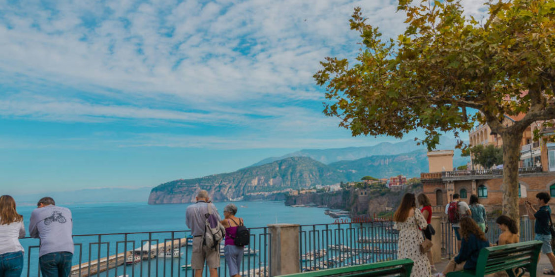 Vue sur Sorrente avec panorama sur la côte, mer Méditerranée et visiteurs au belvédère.