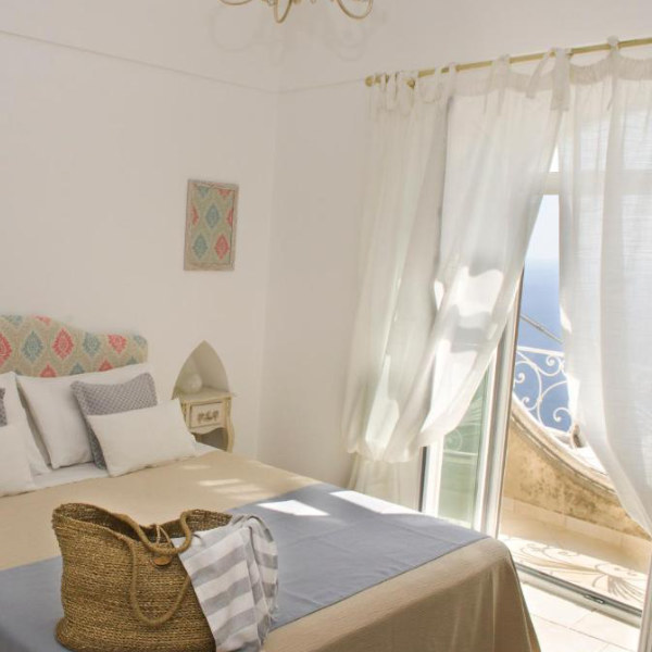 Chambre lumineuse de Casa Romelide à Positano avec balcon vue mer.