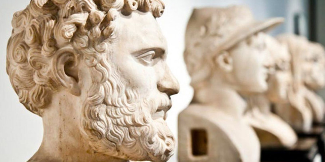 Gros plan sur une rangée de bustes antiques en marbre exposés au MANN.
