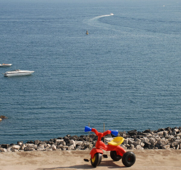 Un petit tricycle face à la mer à Procida.