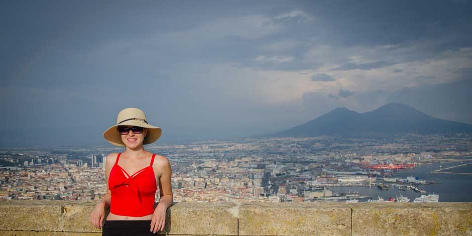 Femme posant devant le panorama de Naples et du Vésuve.