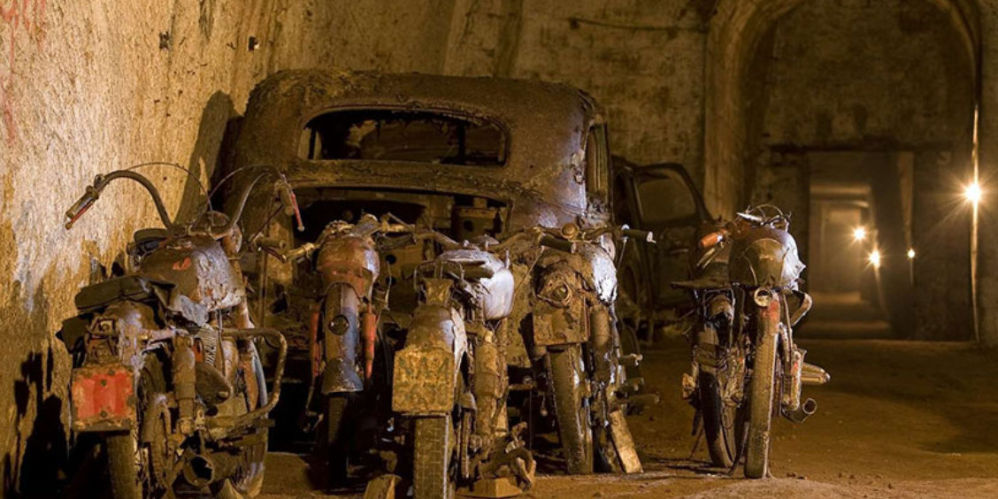 Tunnel Bourbon à Naples avec galeries souterraines, anciens véhicules et ambiance historique.