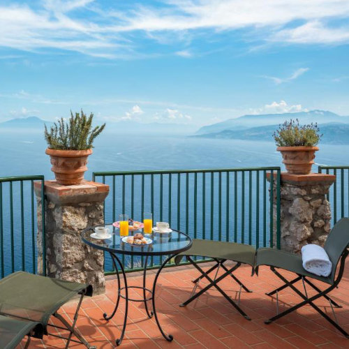 Petit-déjeuner sur la terrasse de l'Hôtel Caesar Augustus avec vue panoramique sur la Méditerranée.