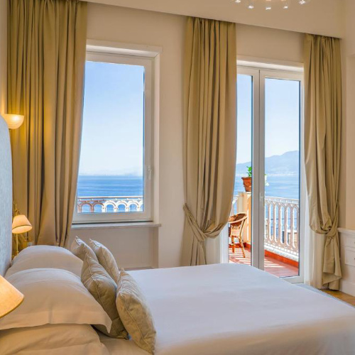 Chambre élégante de l’Hotel Excelsior Vittoria à Sorrente avec balcon vue mer.