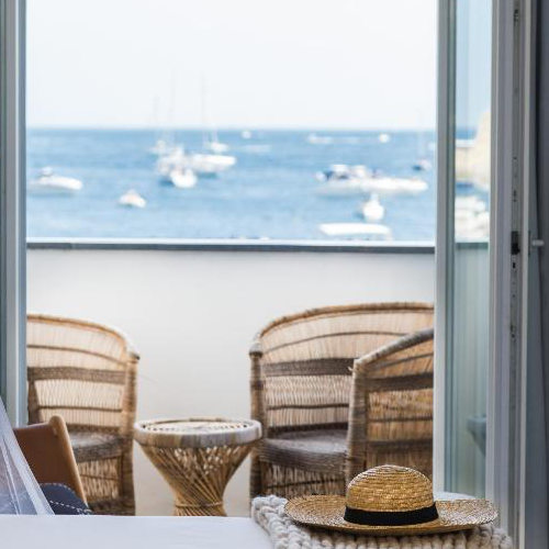 Balcon vue mer avec fauteuils en osier à l'Hôtel San Michele.