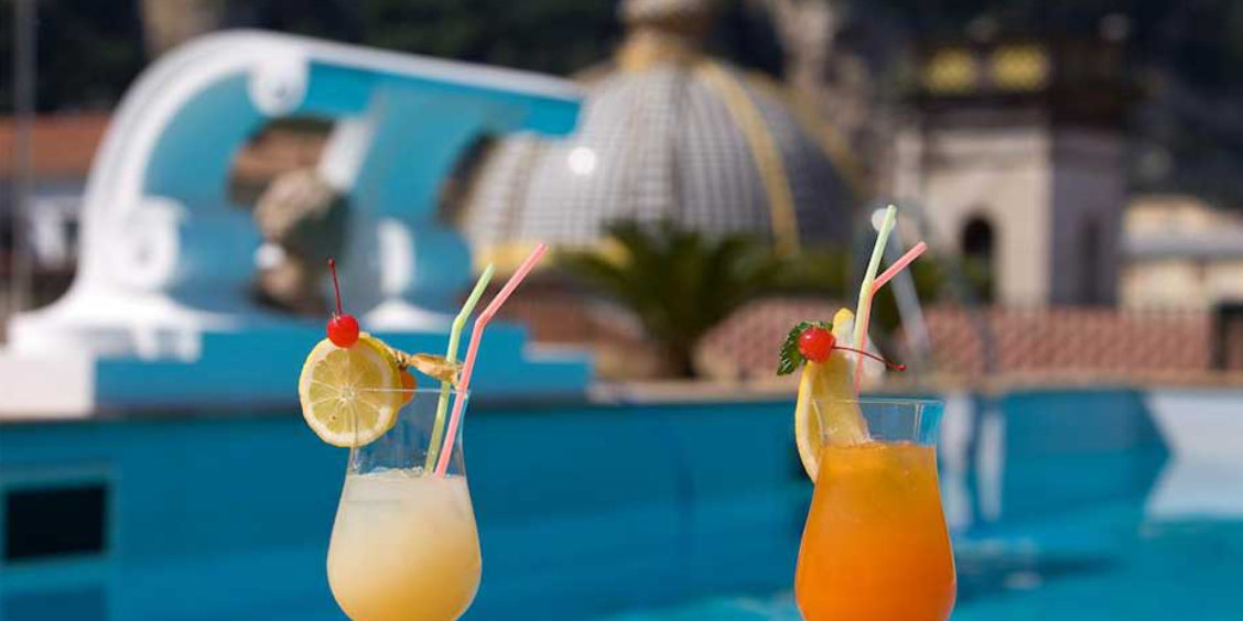 Cocktails sur un rooftop bar à Sorrente avec vue sur la coupole et décor méditerranéen.