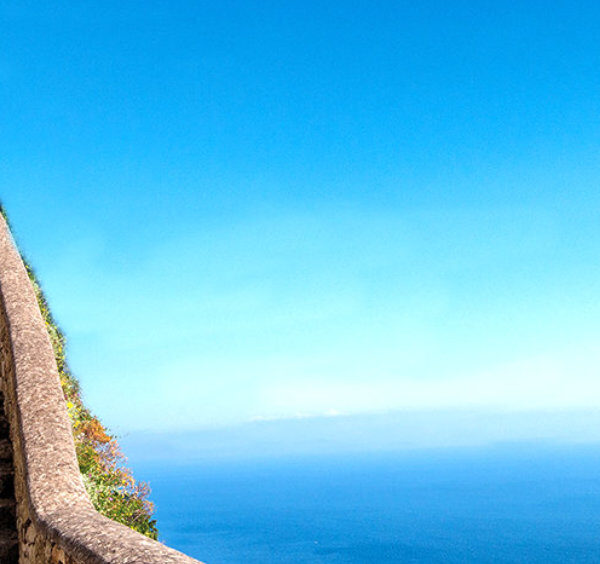 Escalier monumental de la Scala Fenicia à Capri serpentant sur le flanc de la falaise face à la mer bleue.