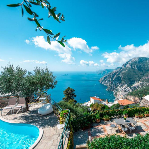 Terrasse de Ville Olimpo à Positano avec piscine, jardin et vue sur la mer.